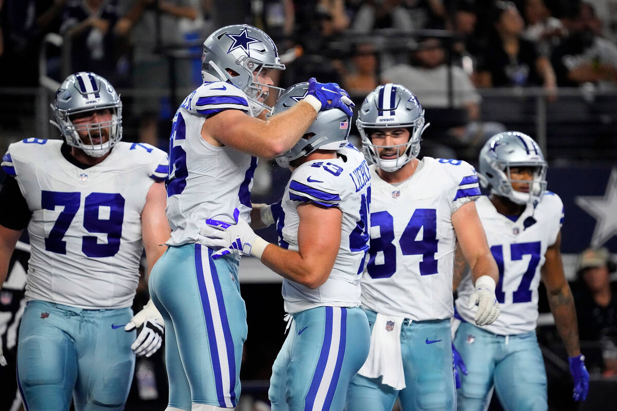 Dallas Cowboys tight end Luke Schoonmaker, center left, and Hunter Luepke, center right, celebr ...