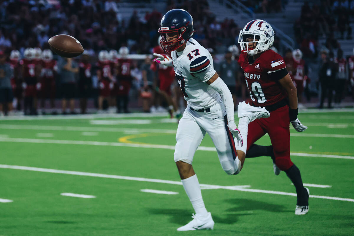 A St. Louis player (17) runs after the ball as Liberty cornerback Peyton Caldwell (20) runs beh ...