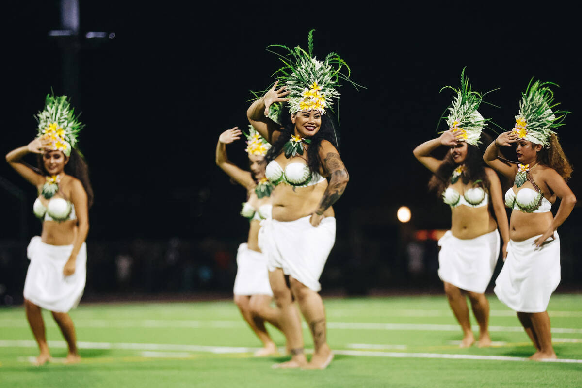 Traditional Hawaiian dancers perform during halftime of an Island Classic game between Liberty ...