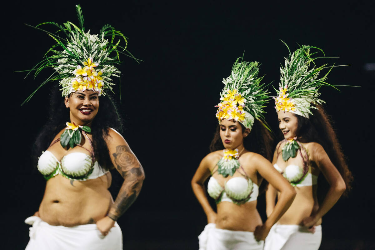Traditional Hawaiian dancers perform during halftime of an Island Classic game between Liberty ...