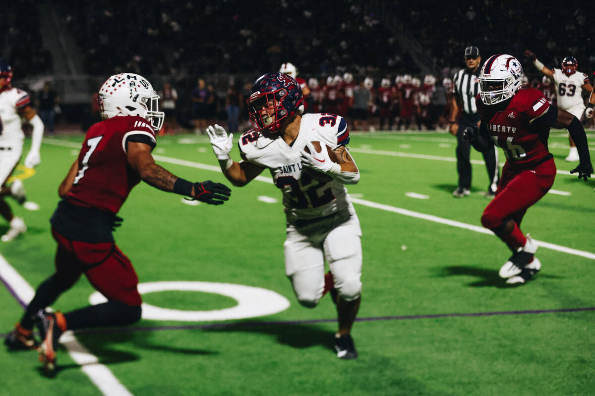 Liberty wide receiver Jayden Robertson (7) looks to tackle a St. Louis player during an Island ...