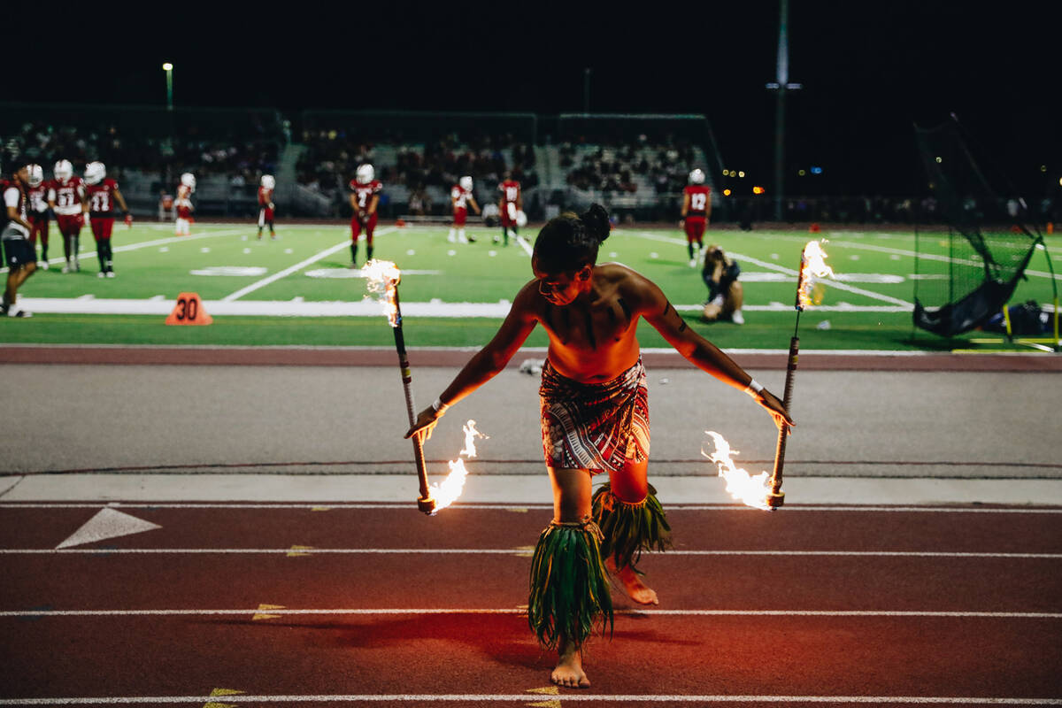 Liberty defensive back Xzavier Smith performs a fire dance during halftime of an Island Classic ...