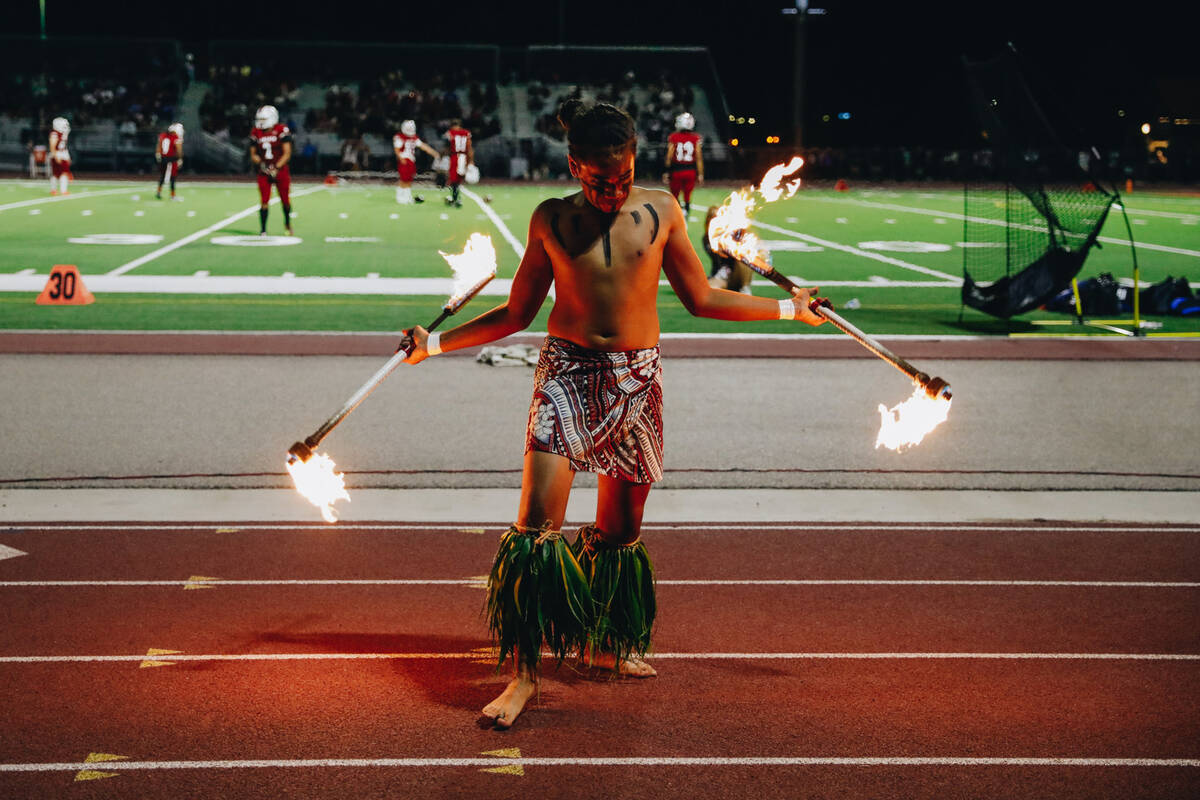 Liberty defensive back Xzavier Smith performs a fire dance during halftime of an Island Classic ...