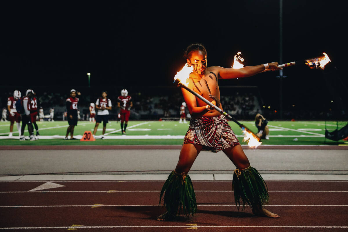 Liberty defensive back Xzavier Smith performs a fire dance during halftime of an Island Classic ...