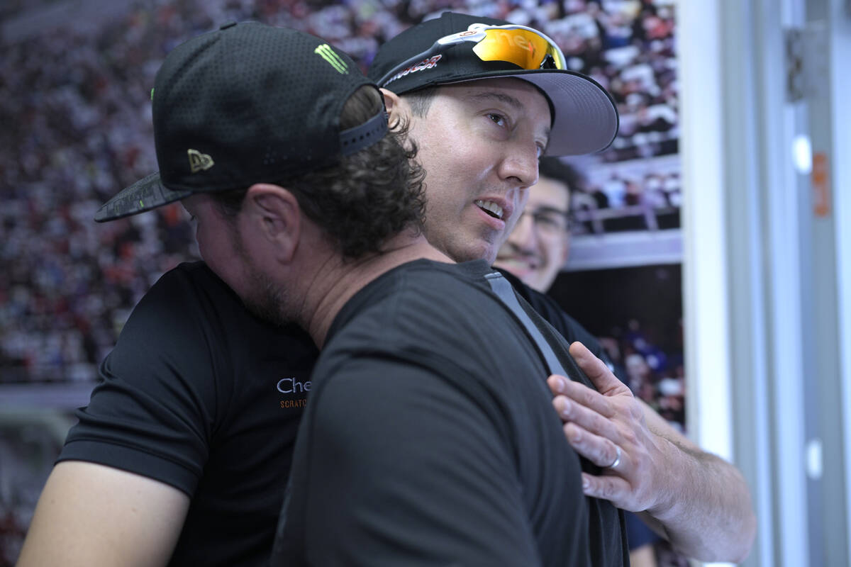 Kurt Busch, front, gets a hug from his brother, Kyle Busch, after announcing his retirement bef ...