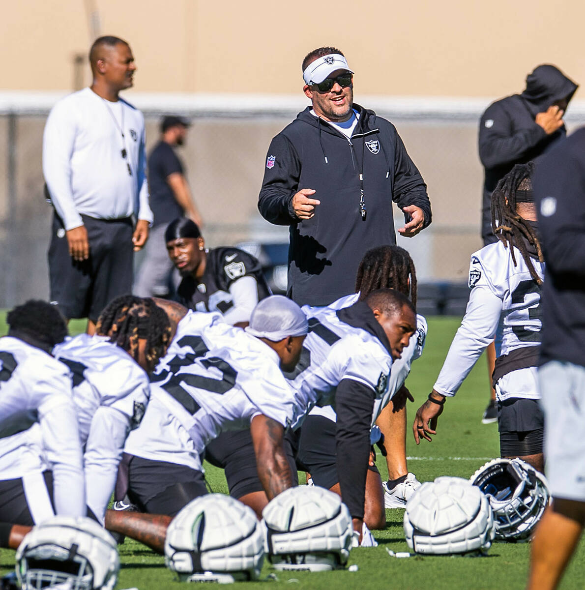 Raiders head coach Josh McDaniels talks with players during training camp at the Intermoun ...