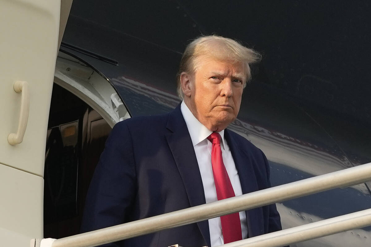 Former President Donald Trump steps off his plane as he arrives at Hartsfield-Jackson Atlanta I ...