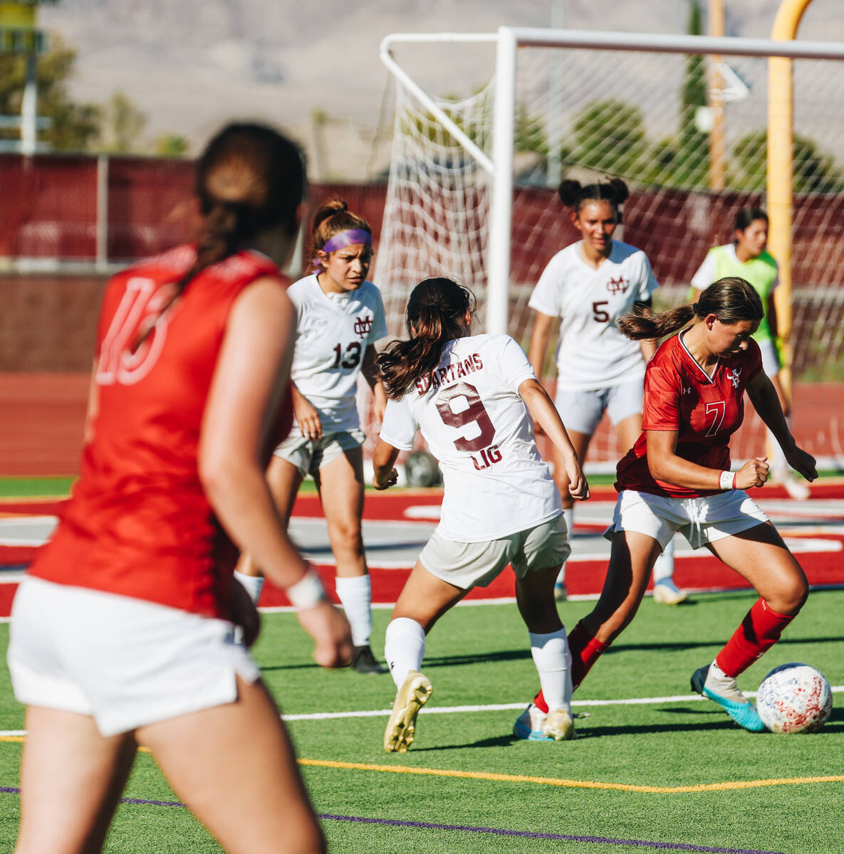 Arbor View player Layla Lindsey (7) kicks the ball as her teammate Sydney Smith (13) looks for ...
