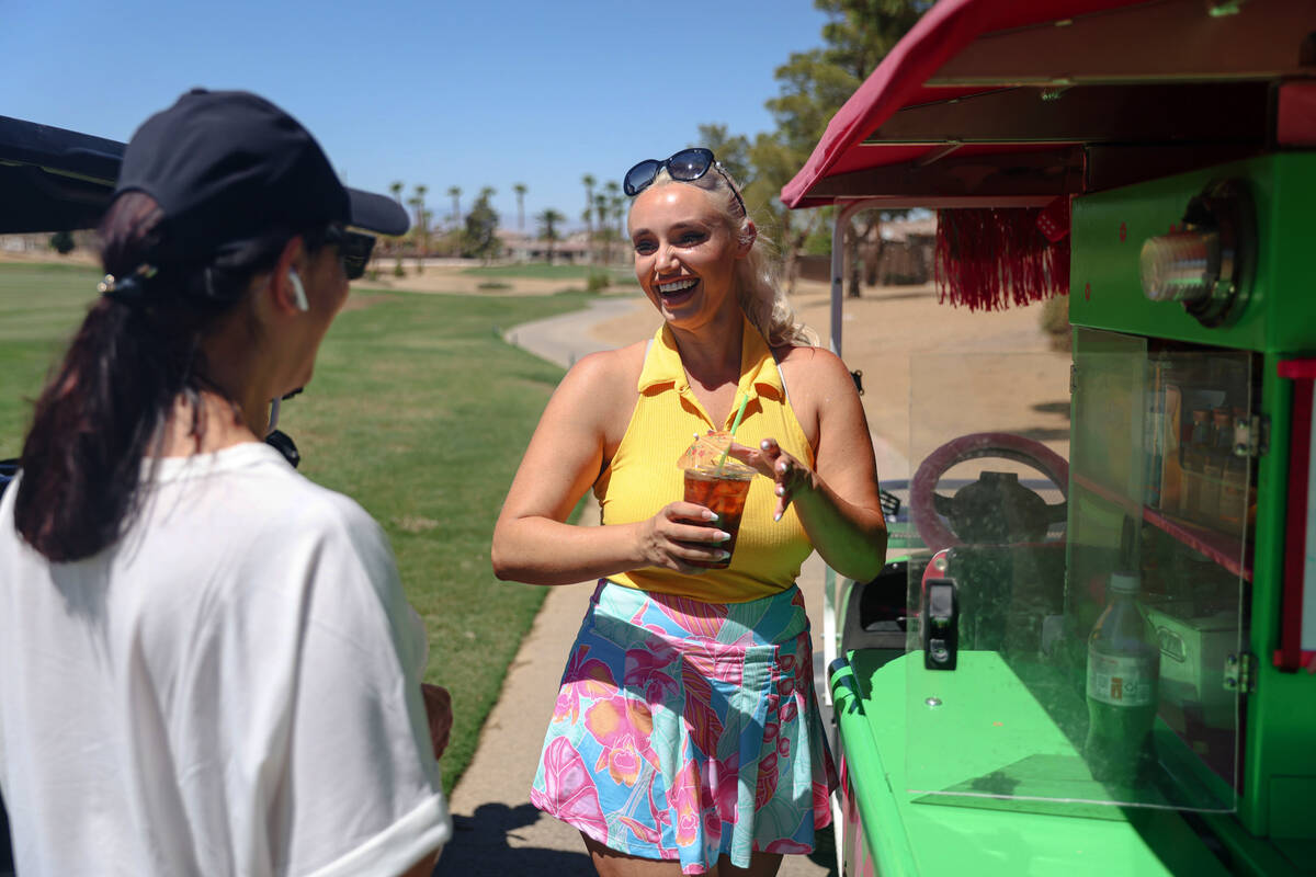 Cass Holland, a cart girl with a massive Tik Tok following, serves a drink to Maria at Chimera ...