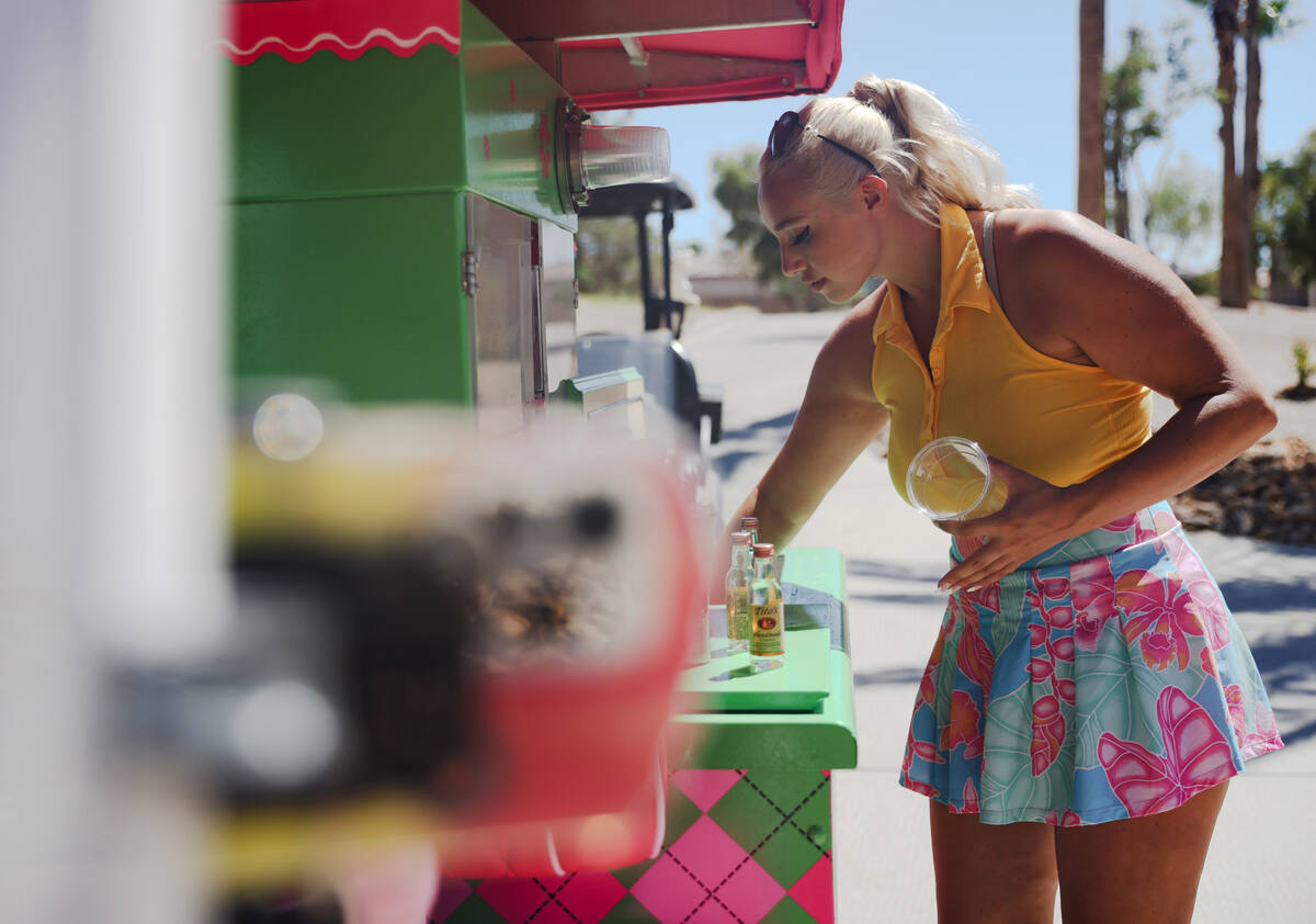 Cass Holland, a cart girl with a massive Tik Tok following, prepares drinks for customers at Ch ...