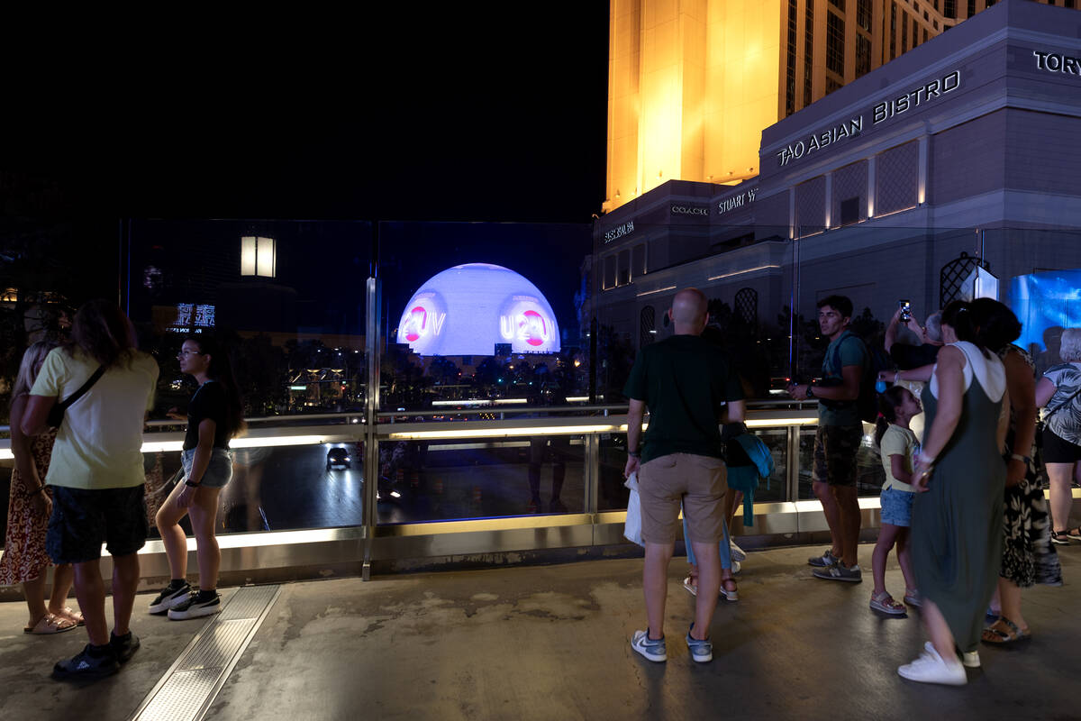 Visitors to the Las Vegas Strip view The Sphere on the pedestrian bridge over Sands Avenue betw ...