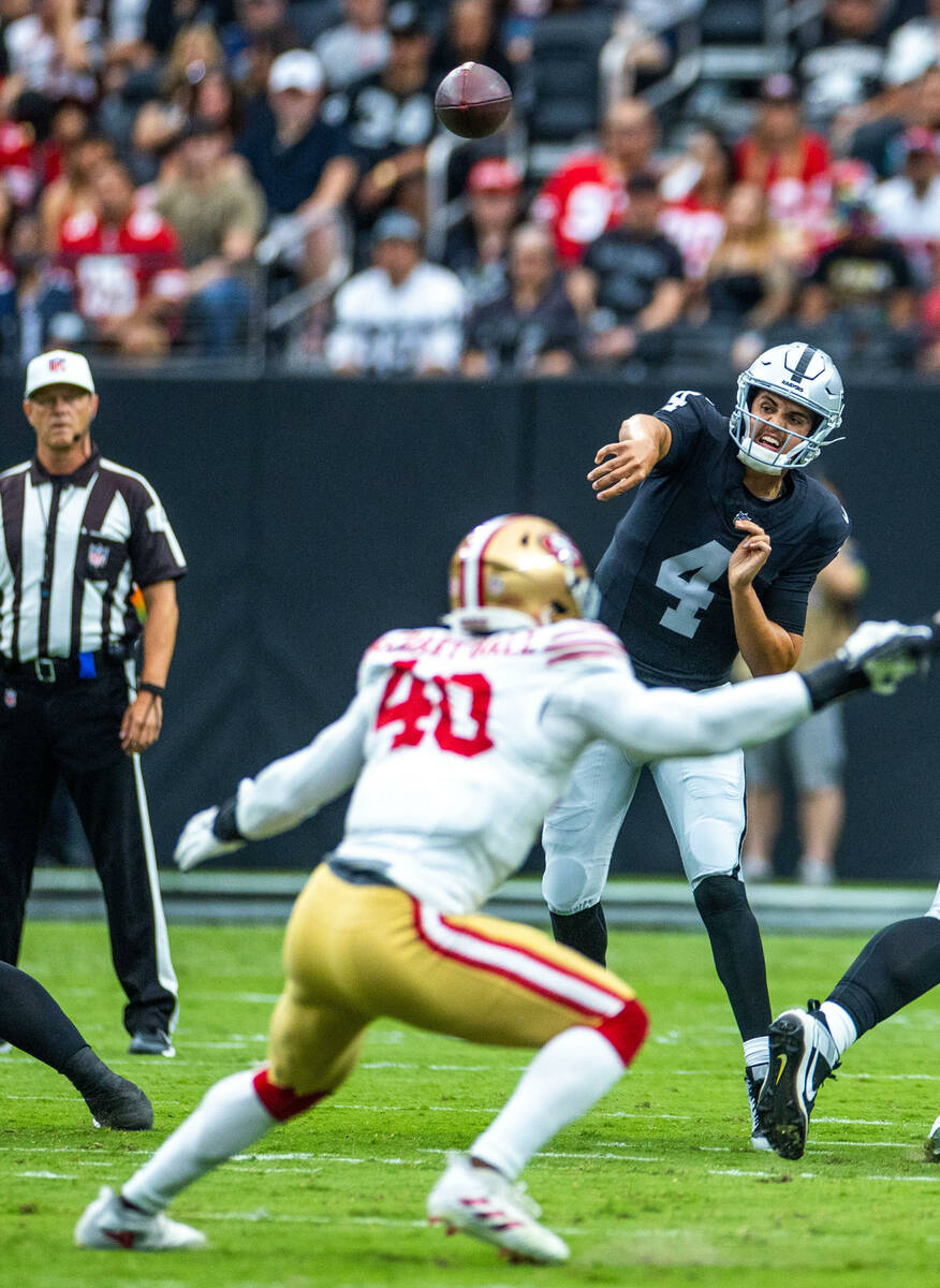 Raiders quarterback Aidan O'Connell (4) passes over San Francisco 49ers linebacker Marcelino Mc ...