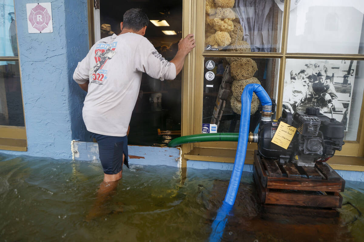 Sponge Diver Supply owner works to deal with the storm surge from Hurricane Idalia in Tarpon Sp ...