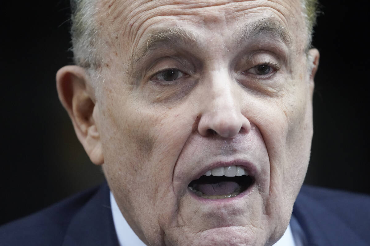 Former Mayor of New York Rudy Giuliani speaks to reporters as he leaves his apartment building ...