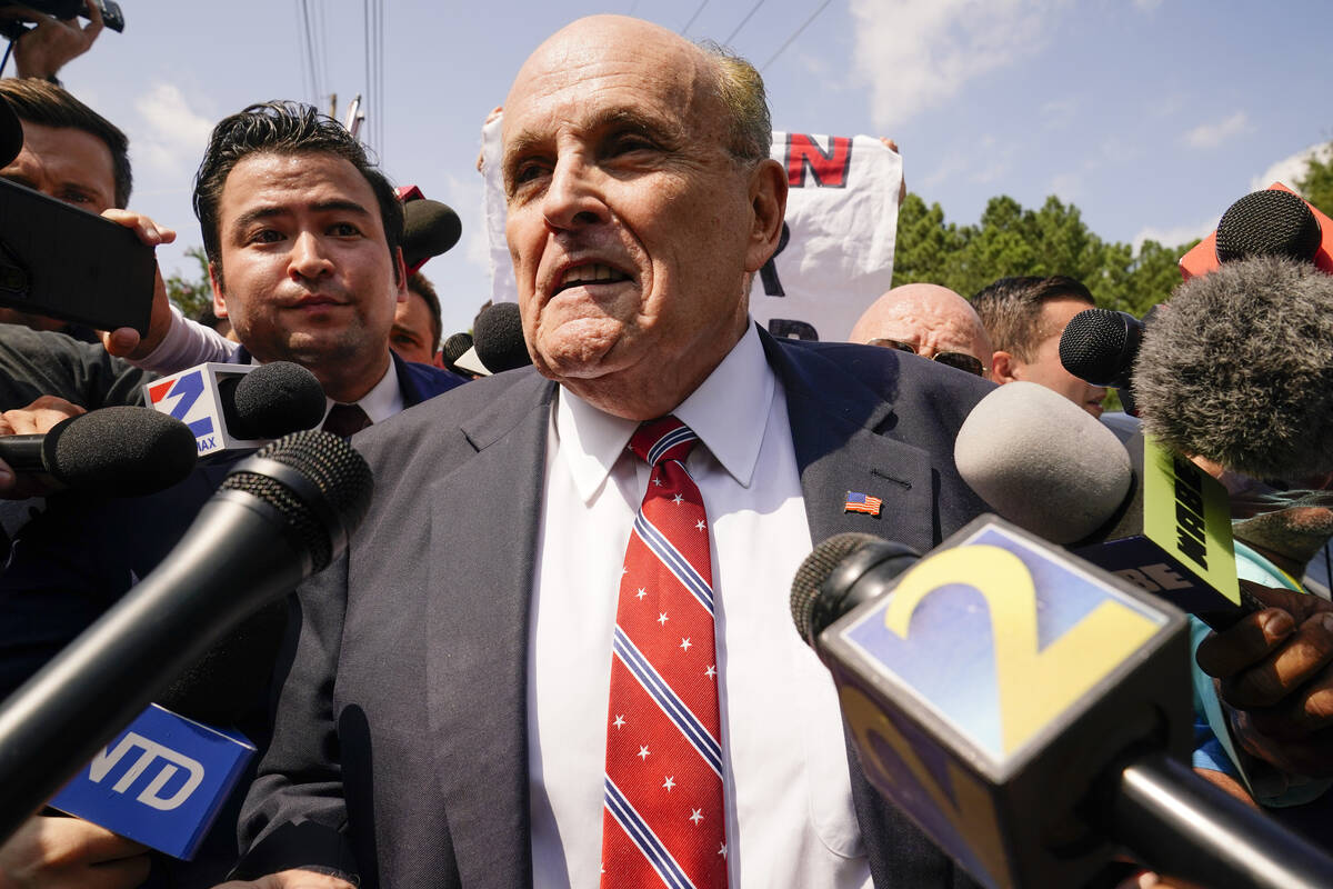 Rudy Giuliani speaks outside the Fulton County jail, Wednesday, Aug. 23, 2023, in Atlanta. Giul ...