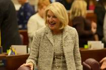 Assemblywoman Heidi Kasama, R-Las Vegas, laughs with lawmakers during the opening of the 82nd S ...