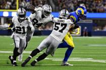 Los Angeles Rams tight end Davis Allen, right, is tackled by Las Vegas Raiders linebacker Drake ...