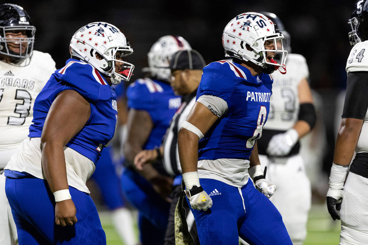 Liberty’s Saumaleato Fuimaono, left, and Jae Beasley (8) celebrate after they made a key ...