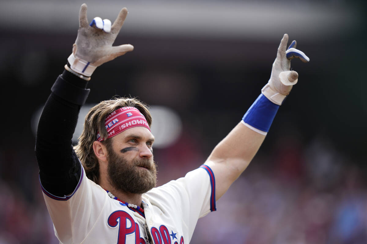 Philadelphia Phillies' Bryce Harper reacts after hitting a two-run home run during the eighth i ...