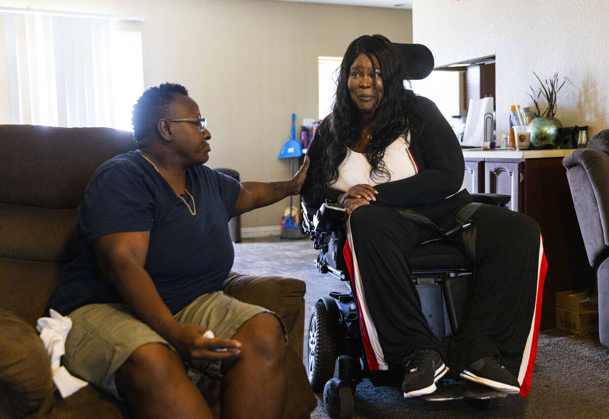 Stephanie Paris, right, is comforted while talking about her home care worker, Nicole Brown, on ...