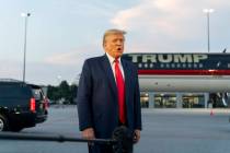 FILE - Former President Donald Trump speaks with reporters before departure from Hartsfield-Jac ...