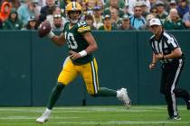 Green Bay Packers quarterback Jordan Love (10) scrambles during a preseason NFL football game a ...
