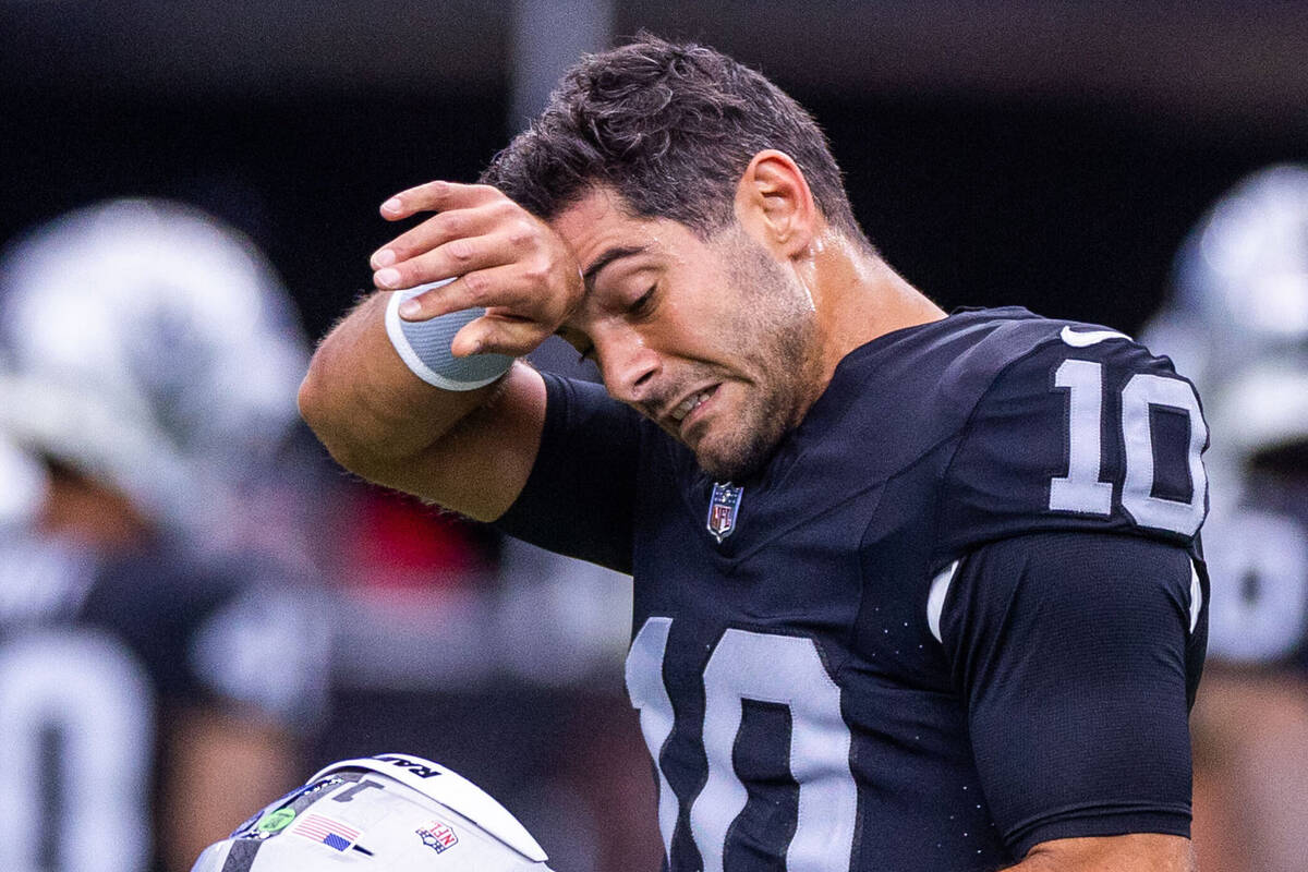 Raiders quarterback Jimmy Garoppolo (10) wipes a little sweat from his brow during warm-ups bef ...