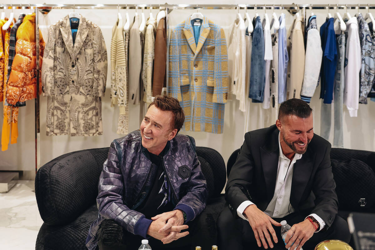 Nicolas Cage, left, has a laugh with designer Philipp Plein during a grand opening event at the ...