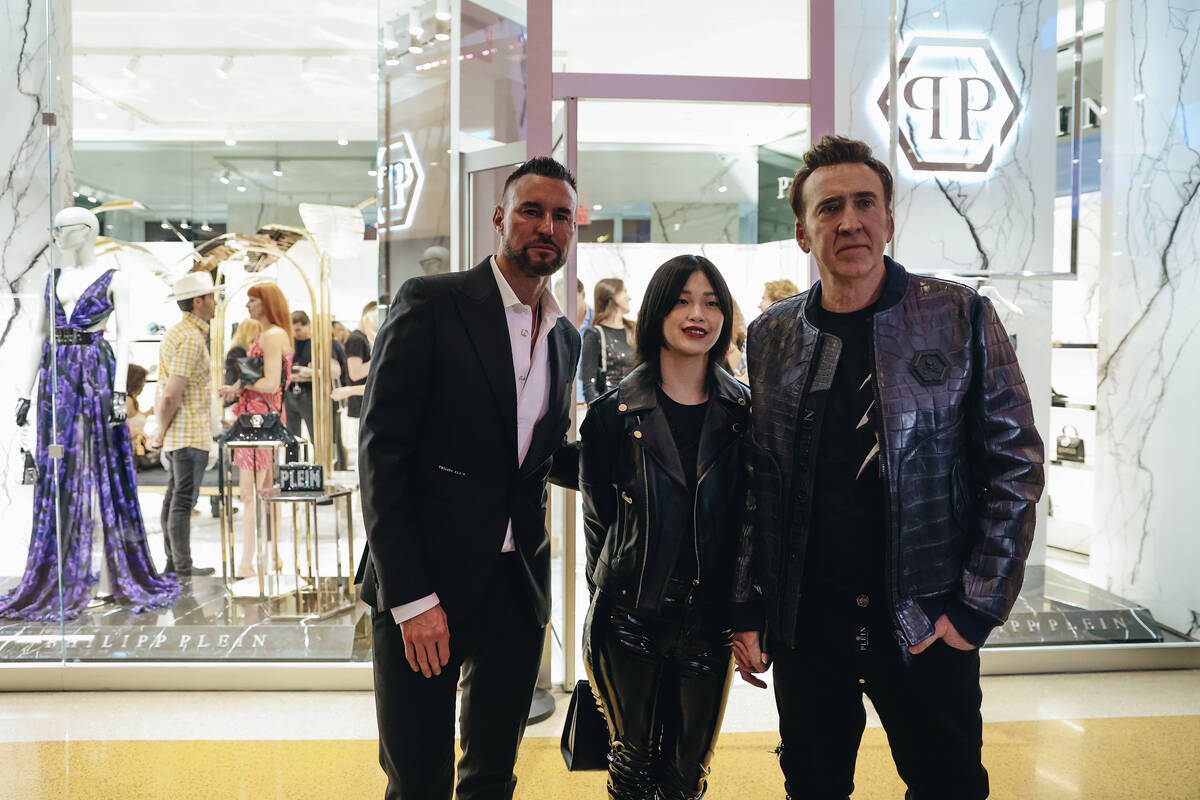 Designer Phillpp Plein, left, poses with Riko Shibata, middle, the wife of Nicolas Cage and Nic ...