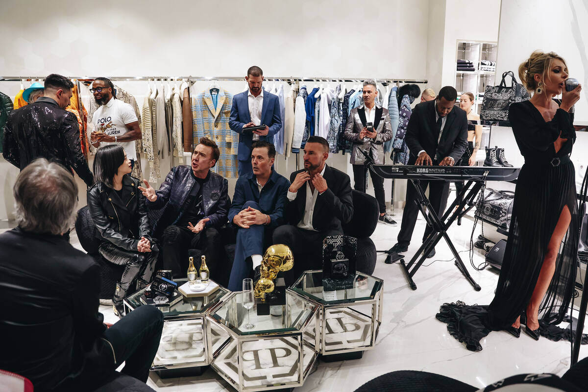 Savannah Lynx, right, sings as Nicolas Cage, second from left, and designer Philipp Plein, seco ...