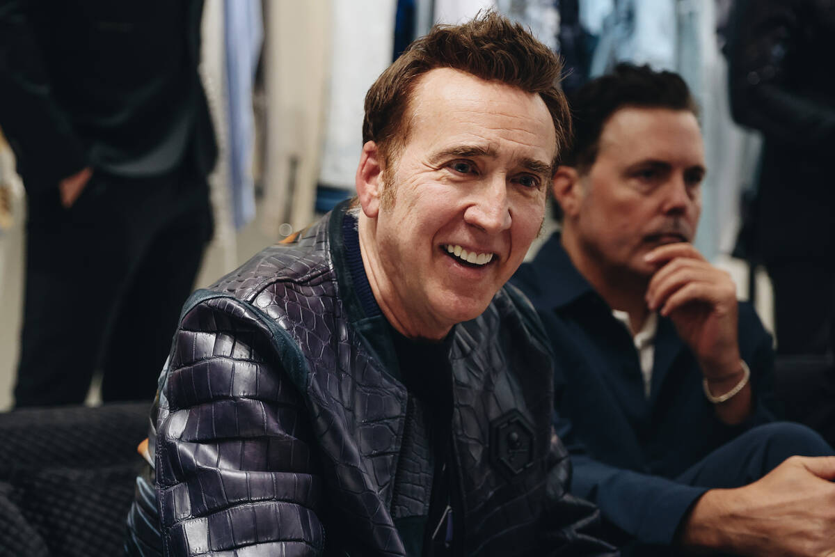 Nicolas Cage converses with people at a grand opening party for the Philipp Plein boutique insi ...