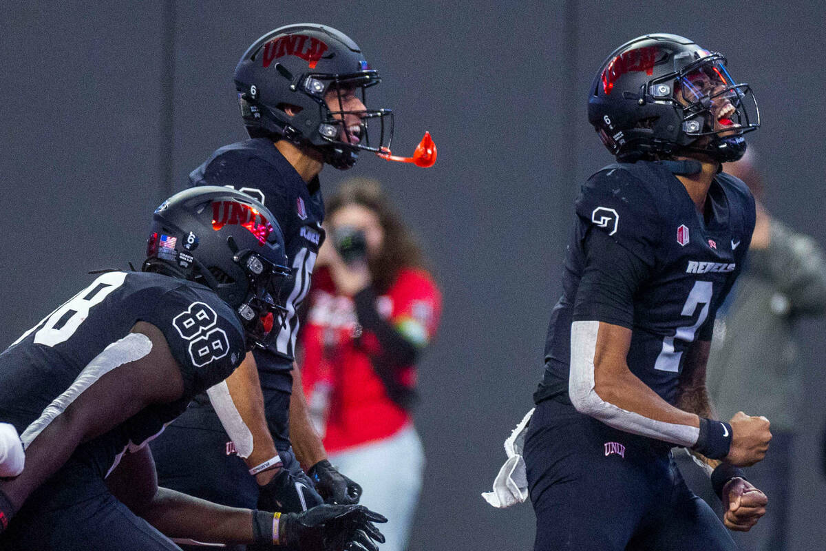 UNLV Rebels quarterback Doug Brumfield (2) celebrates a score with teammates over the Fresno St ...