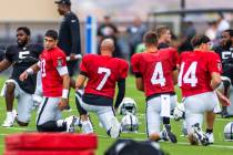 (From left) Raiders quarterback Jimmy Garoppolo (10) and Brian Hoyer (7) talk while stretching ...