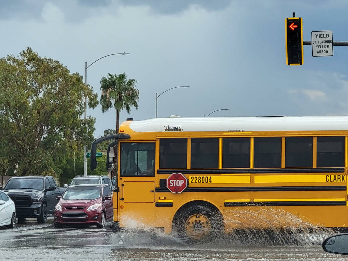 A Clark County School District bus navigates through wet streets on Friday, Sept. 1, 2023. (Nat ...
