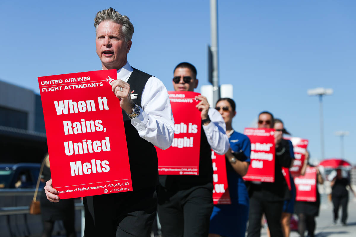 Scott Umfress participates in a picket line march to obtain a new contract and improvements to ...