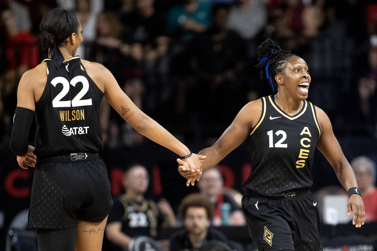Las Vegas Aces forward A'ja Wilson (22) and guard Chelsea Gray (12) slap hands during the first ...