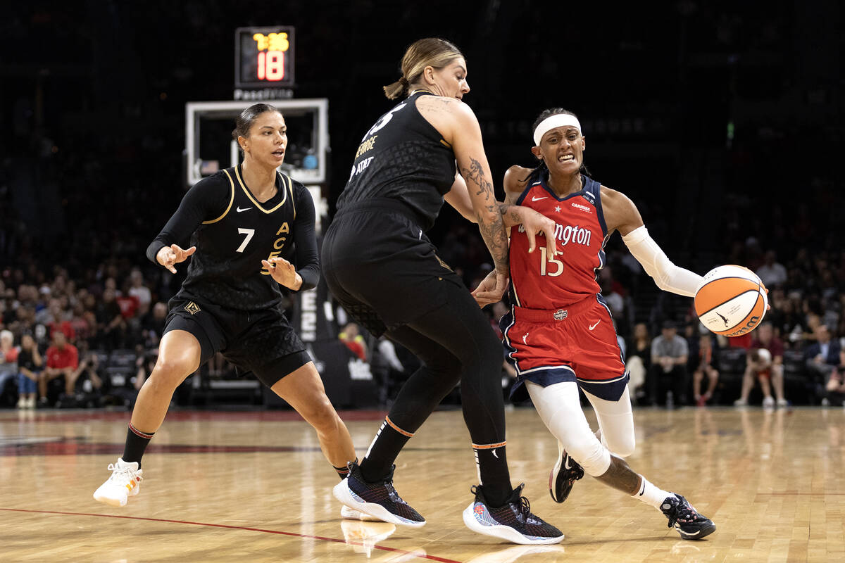 Washington Mystics guard Brittney Sykes (15) drives around Las Vegas Aces forward Alysha Clark ...