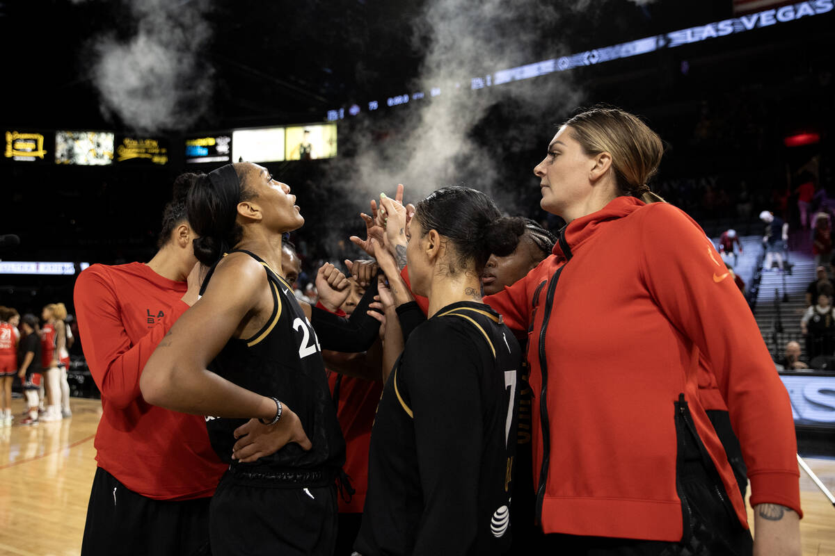 The Las Vegas Aces gather on court after winning a WNBA basketball game against the Washington ...