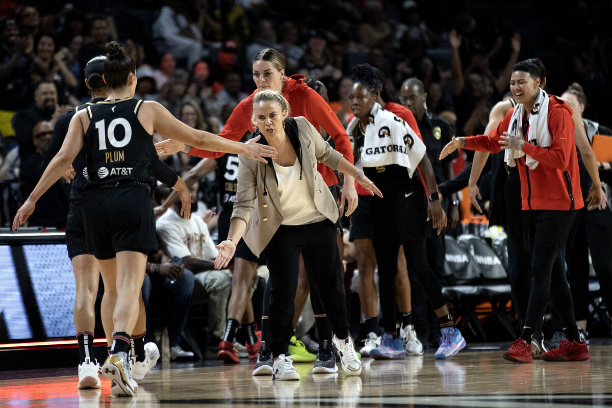 Las Vegas Aces head coach Becky Hammon welcomes her team into a time out during the first half ...