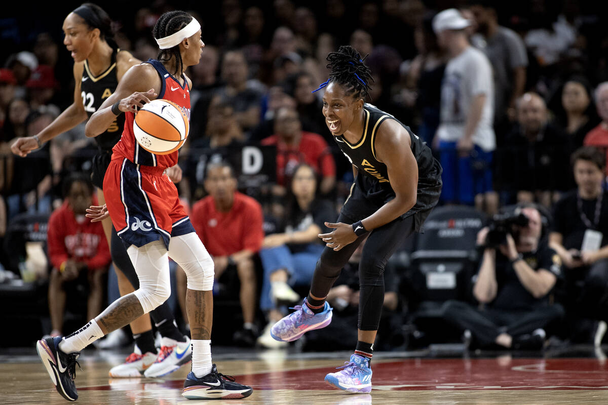 Las Vegas Aces guard Chelsea Gray, right, laughs while guarding Washington Mystics guard Brittn ...