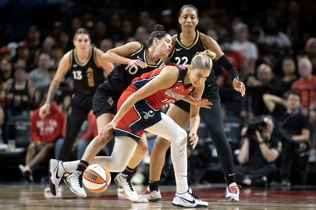 Las Vegas Aces guard Kelsey Plum (10) tangles with Washington Mystics forward Elena Delle Donne ...