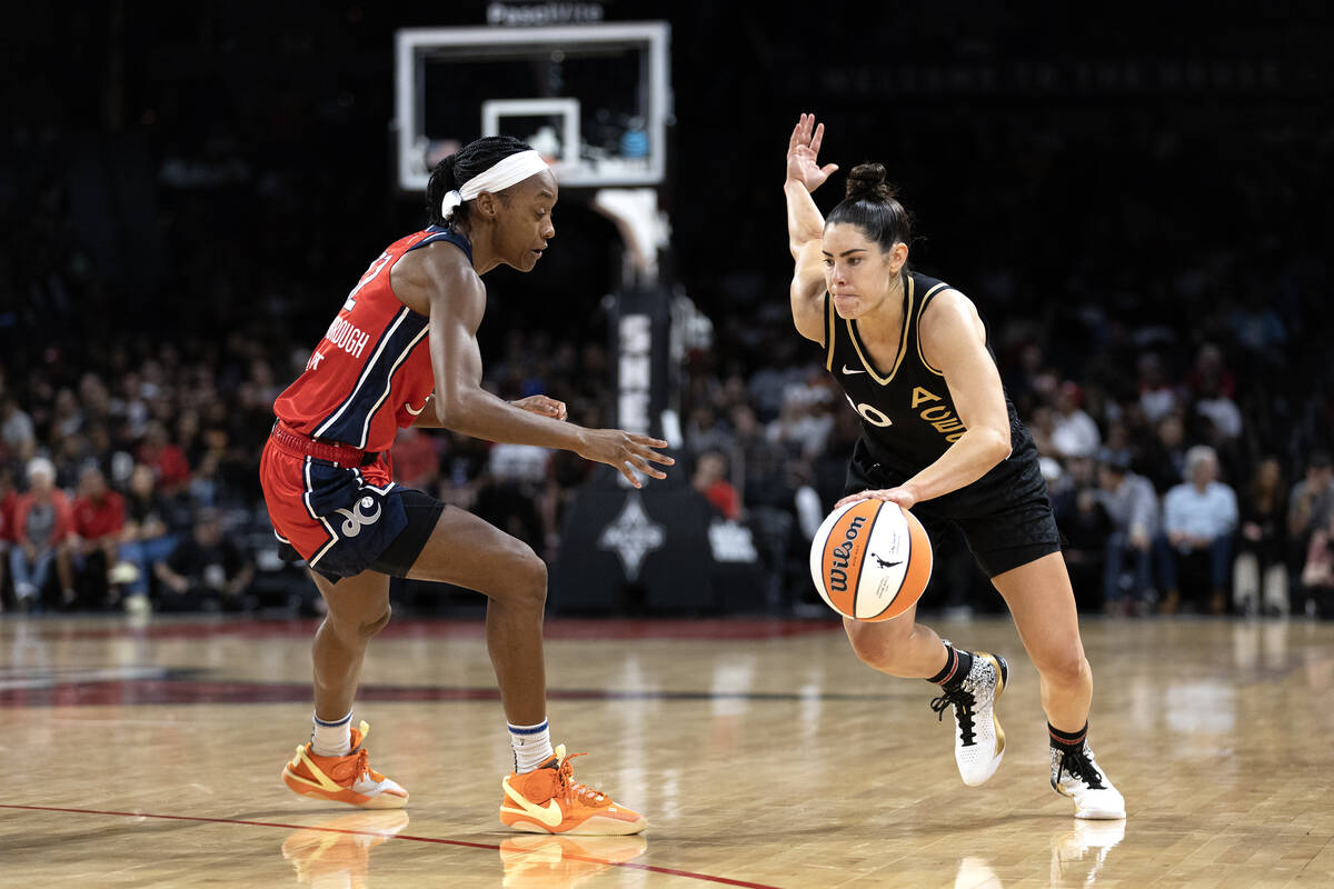 Las Vegas Aces guard Kelsey Plum (10) drives toward the hoop around Washington Mystics guard Sh ...