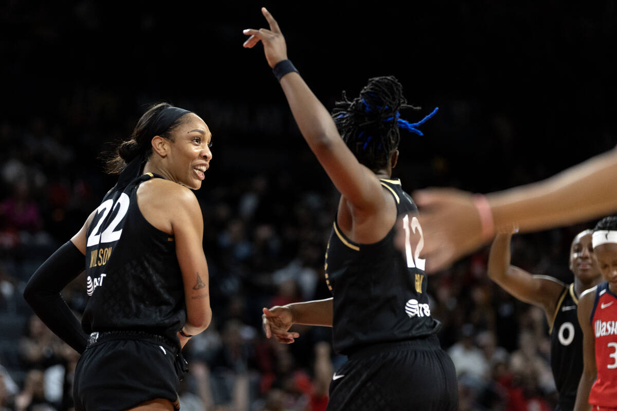 Las Vegas Aces forward A'ja Wilson (22) and guard Chelsea Gray (12) celebrate after referees ca ...