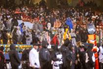Fans brave the rain during the second half of an XFL football game between the Vegas Vipers and ...