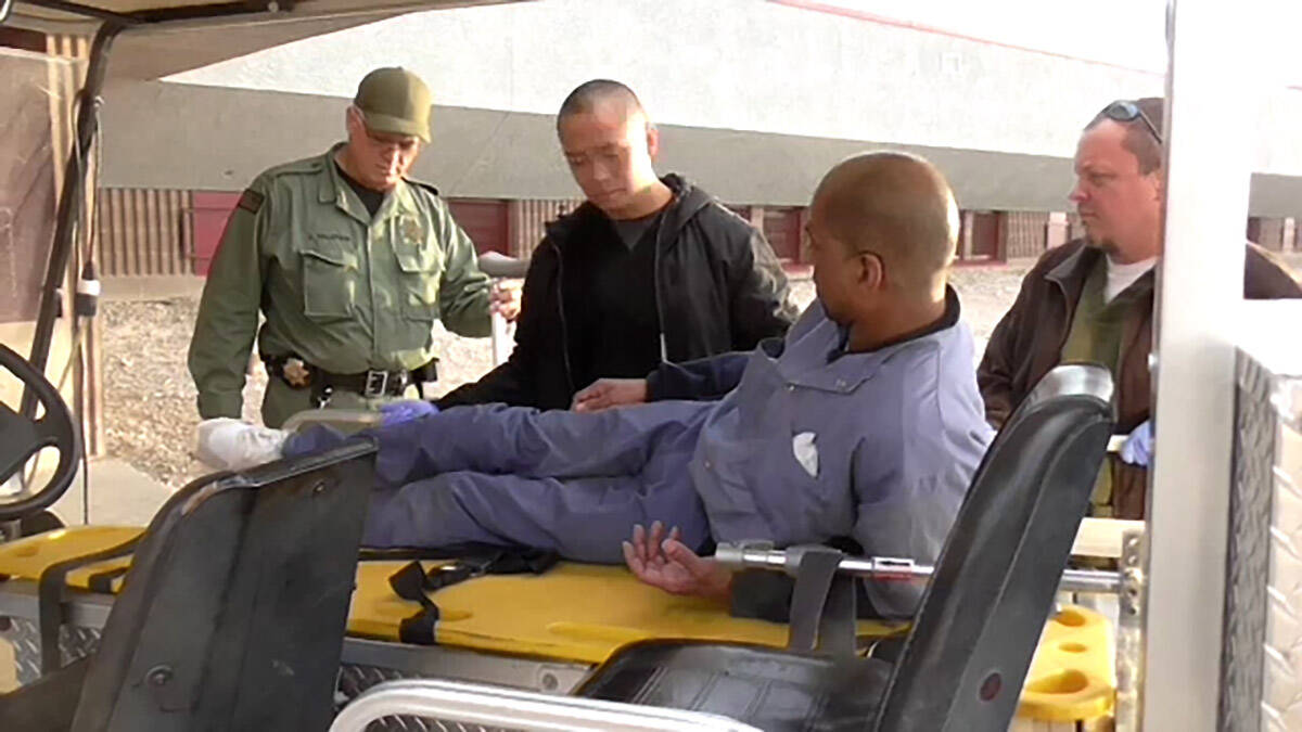 A screenshot from a video shown during the trial depicts inmate Reginald Howard being helped by ...