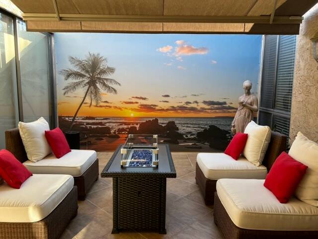 A sunset beach scene as a calming aesthetic to this outdoor sitting area. (Wall Sensations)