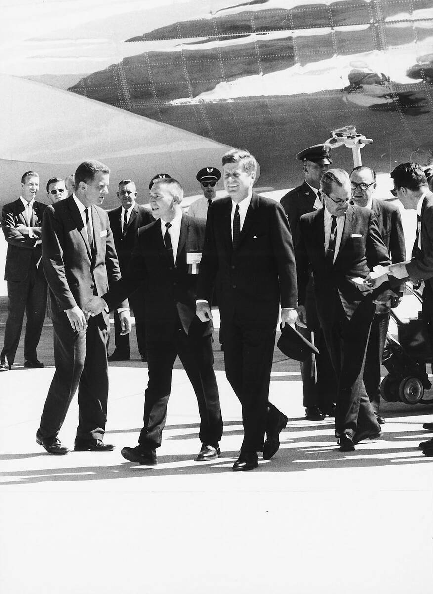Governor Grant Sawyer, second from left, escorts President John F. Kennedy from Air Force One ...
