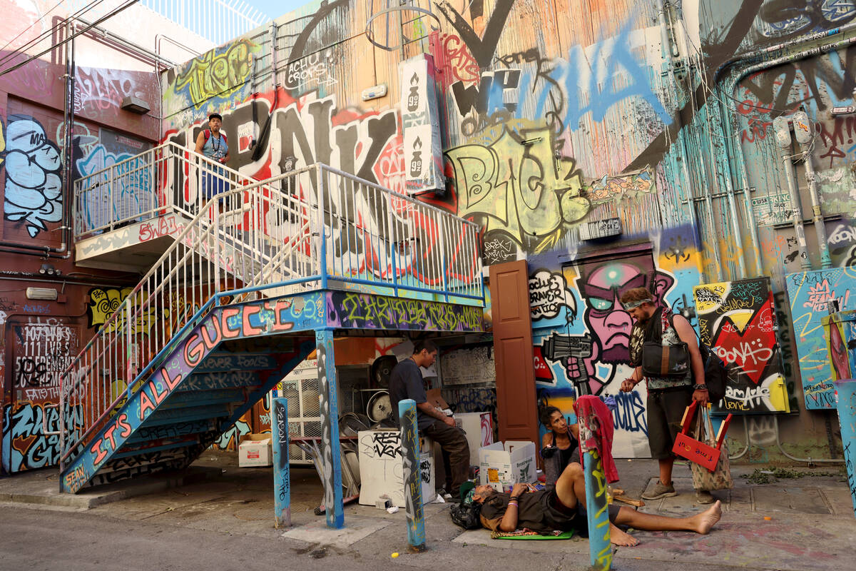 People, some of whom said they are homeless, hang out in an alley near Las Vegas Boulevard and ...