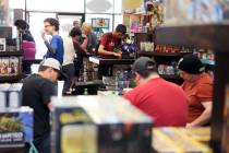 People take part in a Table Top Day event at Shall We Play? game store Saturday, April 5, 2014, ...