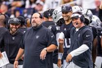 Raiders head coach Josh McDaniels, right, jokes with quarterback Jimmy Garoppolo (10) on the si ...